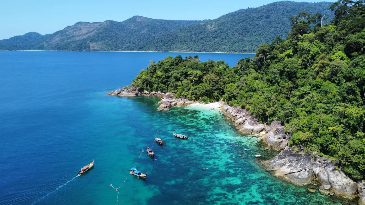 A green headland above a shallow reef off the coast of Phuket