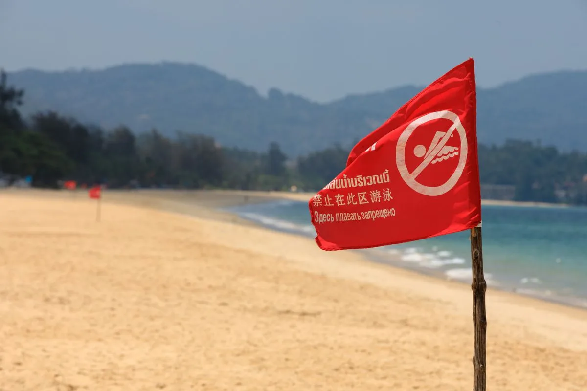 A red swimming warning flag on a Phuket beach